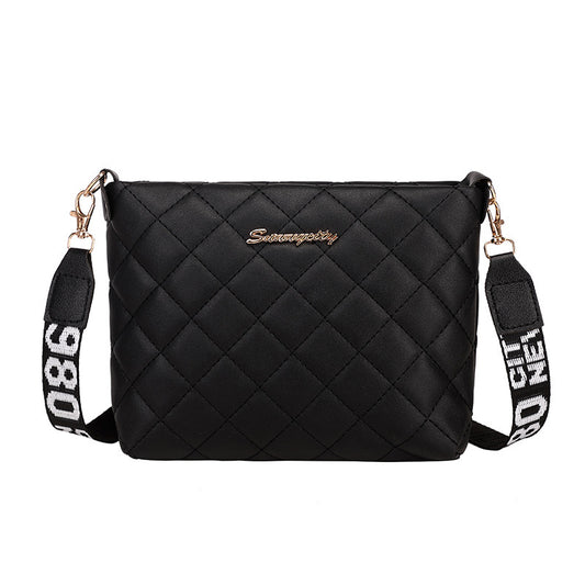 Black diamond grid shoulder bag with wide printed shoulder strap and zip closure with white background.