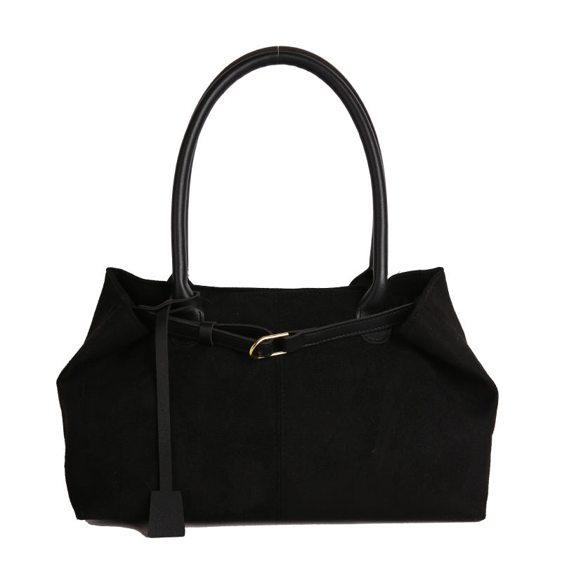 Black handbag with a handle on a white background