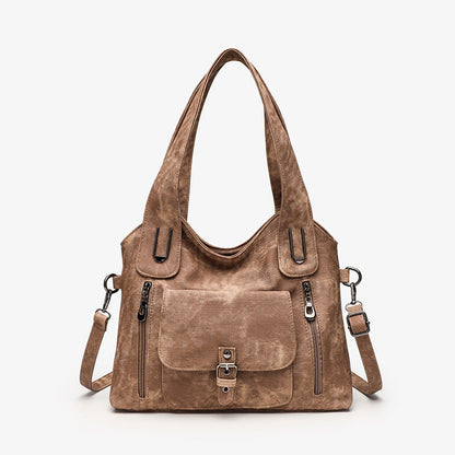 Brown leather handbag with multiple pockets and straps on a white background