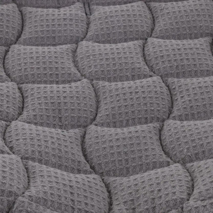 Close-up of a textured gray cushion with a waffle pattern