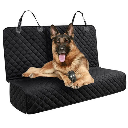 Dog lying on a black quilted car seat cover with a white background