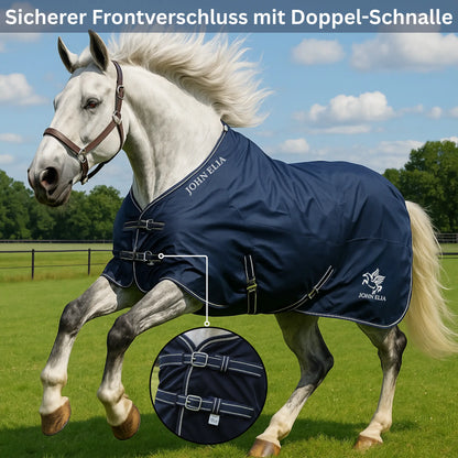 White horse wearing a navy blue rug with John Ella branding in an outdoor setting.