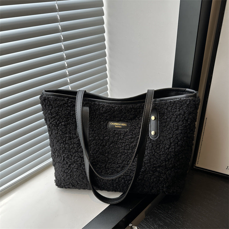 Black plush tote shoulder bag with long shoulder straps