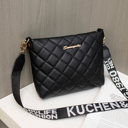 Black diamond grid shoulder bag with wide printed shoulder strap and zip closure.
