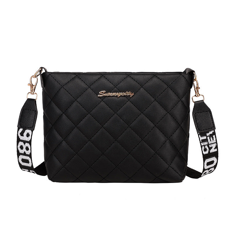 Black diamond grid shoulder bag with wide printed shoulder strap and zip closure with white background.
