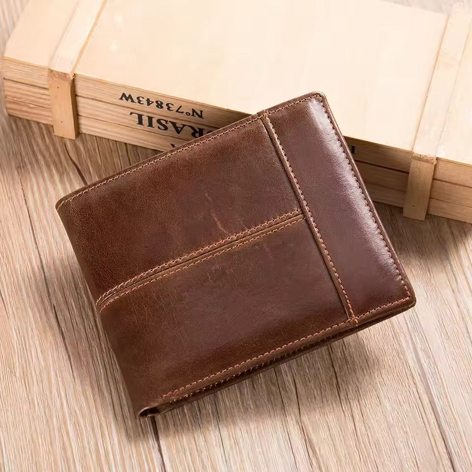 Brown genuine leather RFID wallet for men placed on a wooden surface with a wooden box in the background.
